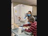 Overlook team members transfer doses of the vaccine into the ultra-low temperature storage.