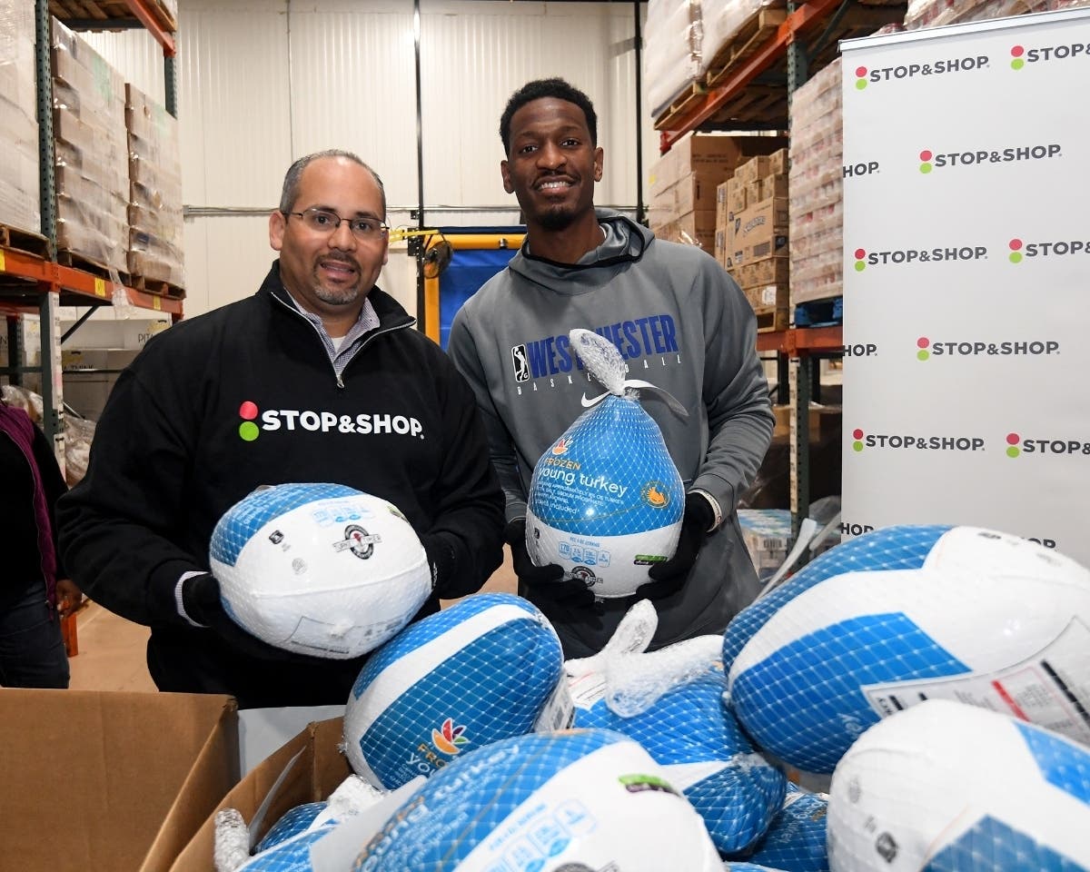 Portchester Stop & Shop Store Manager Edward Pena and Westchester Knicks Forward Andrew White help unload turkeys.