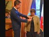 Jessica Neuwirth receiving the insignia of the Knight of the National Order of the Legion of Honor from Jérémie Robert, the Consul General of France in New York.