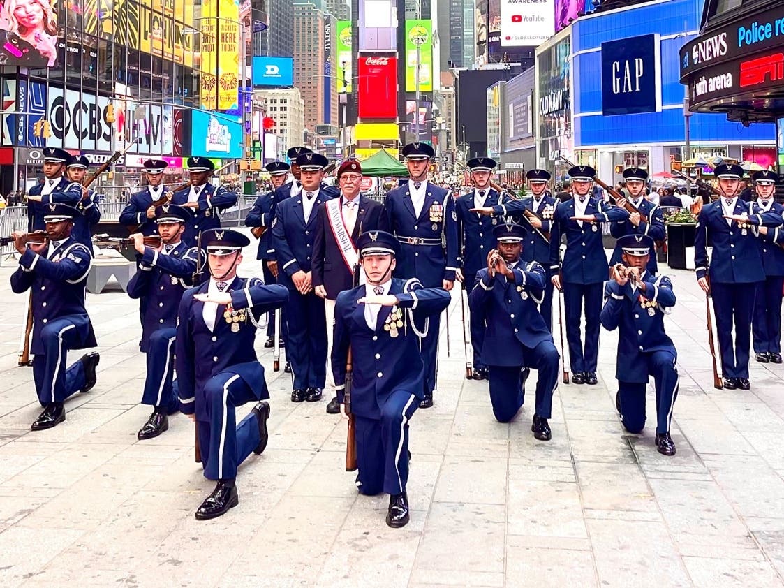 Air Force veteran and local hero Kevin Carrick with the Air Force rifle team in Time Square when the announcement that that he would be the 2021 Parade Grand Marshal was made on the Air Force birthday.