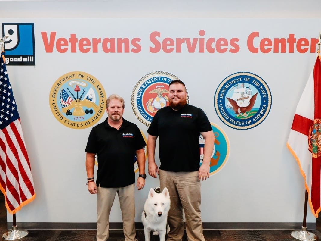 Veterans Services Program team member Randy Wright (left) and Todd Hughes, program manager, with service dog Ghost