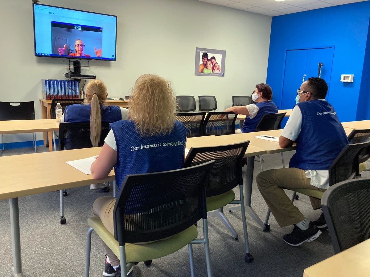 Instructor June Battersby (onscreen) reviews an exercise with Goodwill employees (from l-r) Yanet Sosa, Taimy Leon, Umiliana Rios and Samuel Bonilla-Cotto