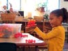 Community Day School preschooler Analise Gallant gets hands-on with a building activity