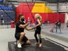 Coach Andres Leon Miller high-fives camper Peyton Nutting
