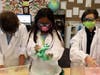 Second graders Elise Morgan, Evangeline Wong and Charles Van Vliet perfect the creation of a non-Newtonian fluid (oobleck)