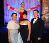 (From l-r) Circus Arts Conservatory founders Dolly Jacobs and Pedro Reis and executive vice president/COO Jennifer Mitchell on the red-carpet dress of former Sailor Circus Academy student Lila Watkins 