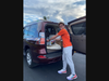 Young volunteer Cullen ‘Cully’ Pfanmiller loads food into a car during a Mobile Pantry