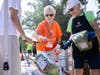 Dedicated All Faiths Food Bank volunteers Lois Lewis (middle) and Fay Donaldson (right) supply a community member with food during a Mobile Pantry
