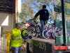 Woodruff & Sons team members Mike Houghton (left) and Willie Tibo Del La Rosa load bikes for delivery to Safe Children Coalition