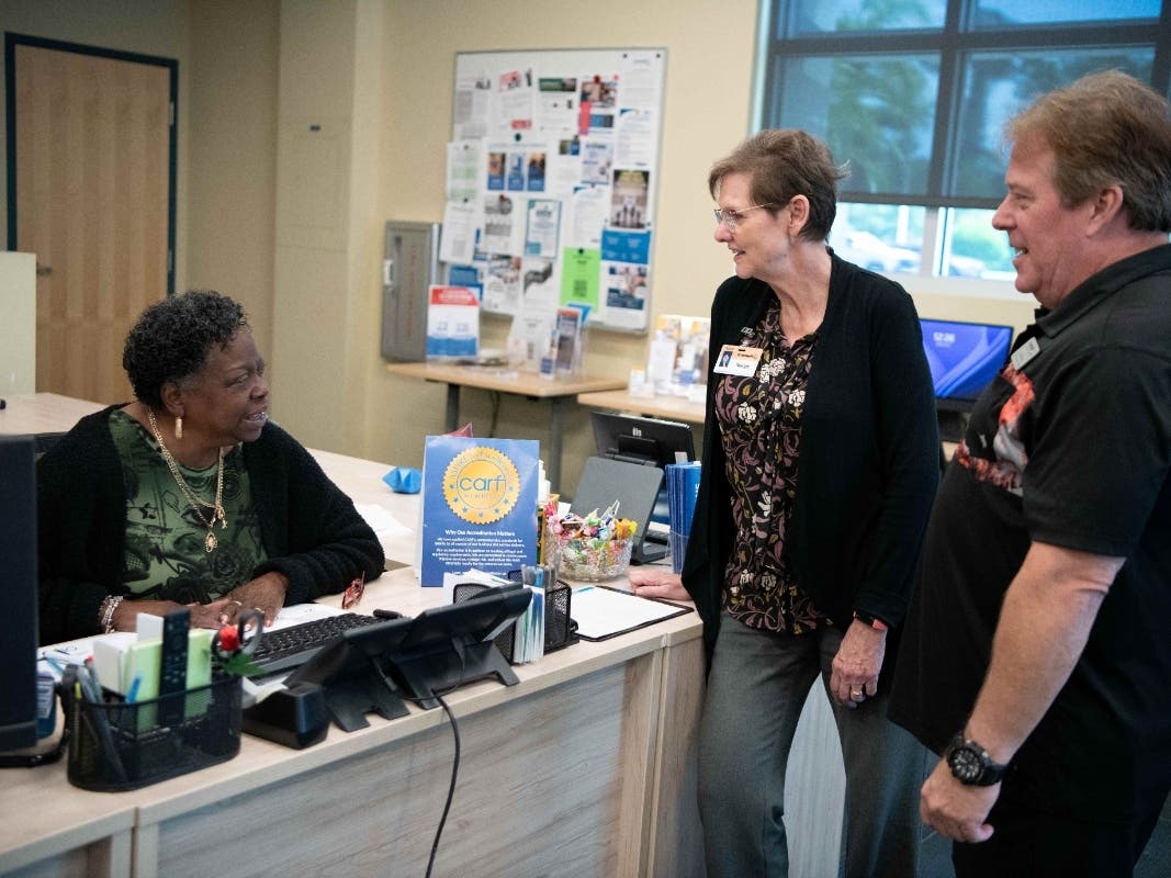 Goodwill Manasota Community Resource Center team member Dorothy Mills, Vice President of Mission Services Margie Genter, and Community Employment Specialist Randy Wright