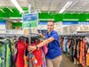 Goodwill Manasota VP of Donated Goods Operations Alexa Olivas brings a fresh rack of clothing to the sales floor