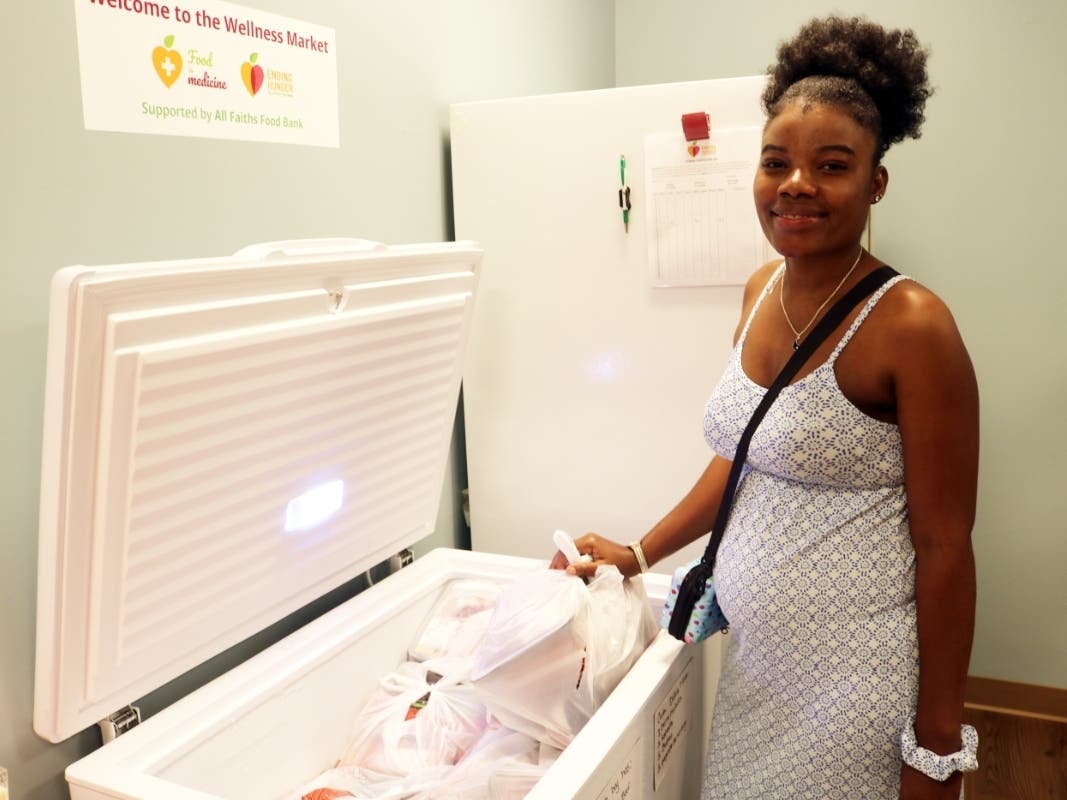 A North Port community member and patient at Johns Hopkins All Children’s Hospital selects from the food available at the Wellness Market located there