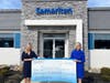 Samaritan’s 2022 Gala Chair Jamie Bratton of Innovative Benefit Planning (left) and Samaritan President/CEO Mary Ann Boccolini (right) stand with a $151,000 donation from the organization’s 2022 Celebration of Life: Above and Beyond Gala.