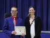 Connor from Y.A.L.E. School accepts an award from Lora Marie Durr, President, Art Educators of New Jersey. Connor was also thanked at the awards ceremony for creating the prize ribbons for the show in the Y.A.L.E. School Vocational Skills Lab and Co-op.