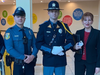Members of the Voorhees Police Department with Stella Sytnik of Voorhees Township at the Fallen Comrade Ceremony at Voorhees Town Center. 