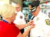 A member of the Voorhees Police Department receives a First Responders’ pin from Sharon Wenner of Samaritan.