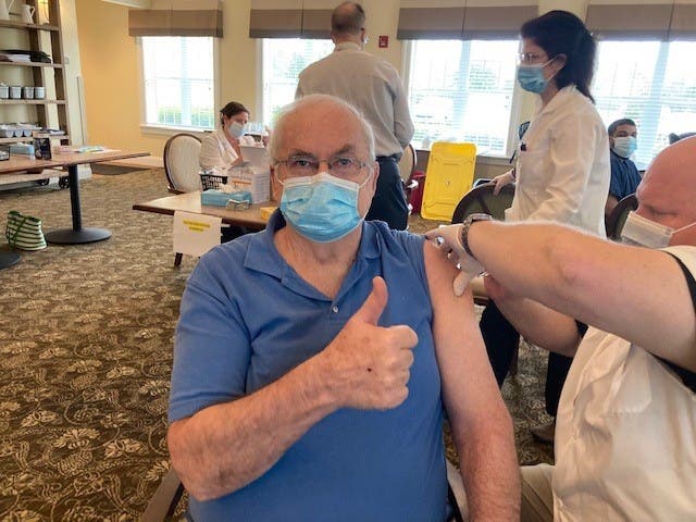 Walter Kleiwer, an essential caregiver whose wife lives at the community, received the first dose of his COVID-19 vaccine.