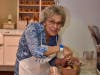 Janet Lastarza, 91, slices banana bread that she made with help from the Nayas at The Watermark at Vistawilla
