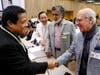 Dr. Hong, second left, looks on as representatives from Kiribati and Bahrain, two countries that have partnered along with FOWPAL to promote peace and conscience, greet one another. 