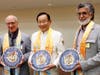 Dr. Hong, president of FOWPAL, center, presents the compass clock of conscience to Bahrain's Cabinet Affairs Minister, left, and president of Prince Khalifa bin Salman Al Khalifa Sustainable Development Award Committee, right
