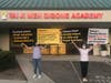 Tai Ji Men dizi hold posters to accuse the Taiwanese government of abusing their human rights in front of the Tai Ji Men Qigong Academy in Cupertino, California, on August 15, 2020.