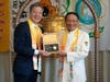 Former U.S. Ambassador-at-Large for International Religious Freedom Sam Brownback, left, is presented with the “Key to the Heart” after ringing the Bell of World Peace and Love in Washington, D.C. on June 28, 2022. 
