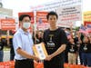 Eric Chou, director of the Administrative Division of Taipei Economic and Cultural Representative Office in the U.S. (TECRO), left, came out to accept a statement from Matthew Chen, a youth representative of Tai Ji Men members. 