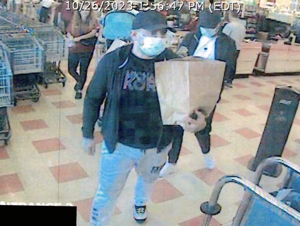 A surveillance image showing two suspects who placed a skimming device on a credit card machine in Market Basket in Reading. Anyone with information on their identities is asked to call Reading Police at 781-944-1212. 