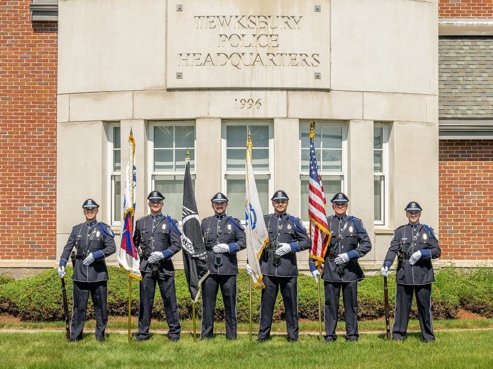 The Tewksbury Police Honor Guard stands in front of the police station. 