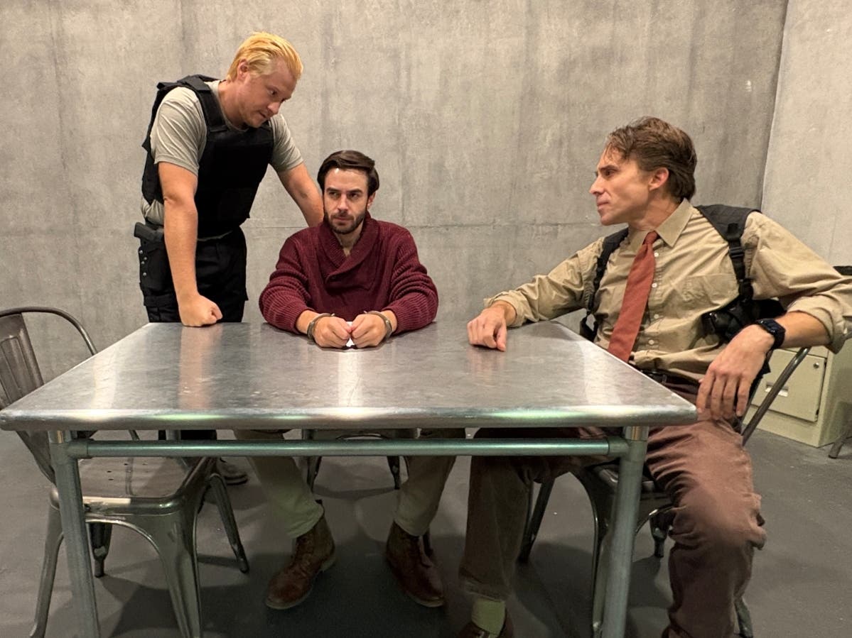 Katurian (AJ Lyman, center) is interrogated by two cops played by Mark Damon (left) and Casey Preston (right) in The Pillowman at Colonial Chorus Players October 2–11. Photo courtesy of Colonial Chorus Players.