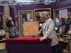 Appraiser G. Amory LeCuyer (right) of Hampton House Auctions admires a beautiful Howard Mehring painting that was salvaged from a trash heap.