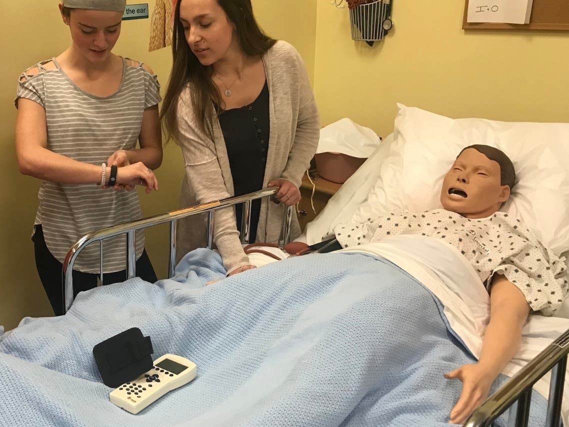 Pre-Nursing students at Hunterdon County Polytech Career & Technical High School, Stephanie Nissel and Kaitlyn Bodder, work together to check the vital signs of SimMan.