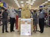 Award-winning sand sculptors, husband and wife team of John Gowdy and Laura Cimador, stand proudly alongside their sand replica of the Ronald McDonald House of Southern New Jersey in ShopRite of West Berlin. 