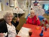 Carol Stanio (L) and Catherine Dangelatonio (R) share smiles and cocktails during the holiday weekend party at Rose Tree Place. 


