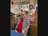 Rose Tree Place resident Marcia Finn sports her festive holiday apparel as she holds up her party umbrella at a pre-July 4th party at the retirement community. 

