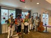 Mummers from The Stringband Novelties (L) and The Hardly Ables String Band (R) both dressed to impress as they entertained Rose Tree Place residents at a pre-July 4th party. 