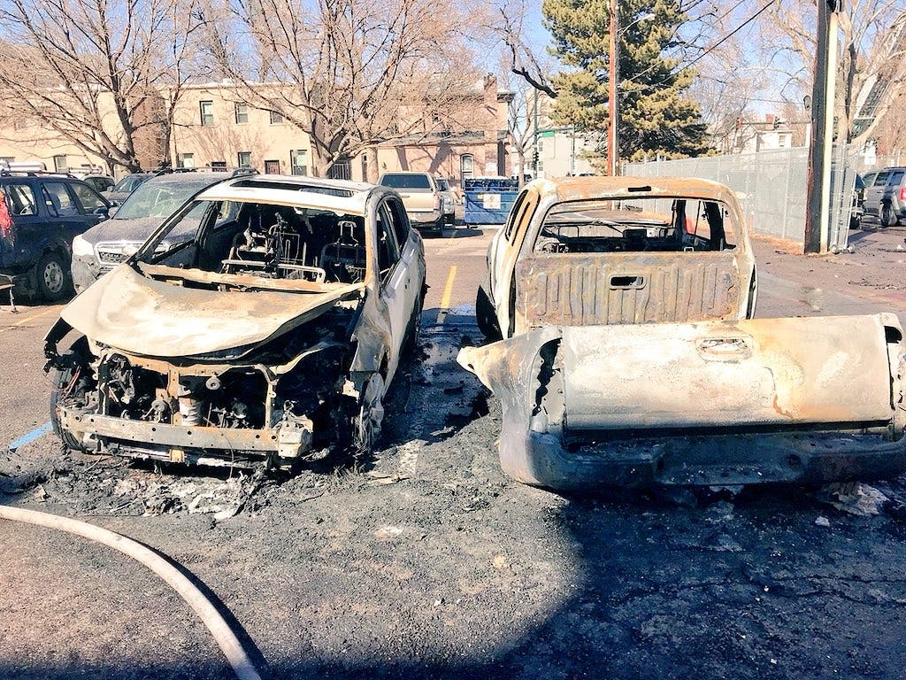 burned vehicles in the parking lot of a construction site fire at 18th and North Emerson Street in Denver. Via Denver Fire Dept.