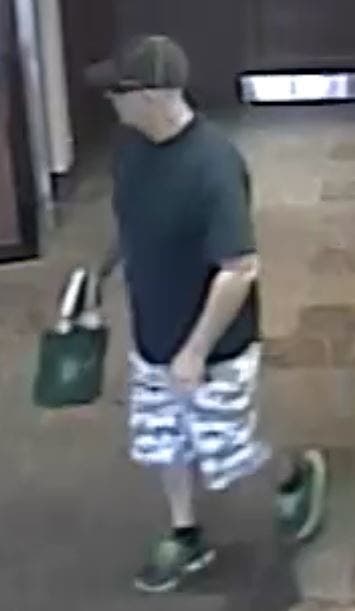 Alleged Littleton bank robber in patterned shorts carrying tote bag. Alleged Littleton bank robber in patterned shorts carrying tote bag.