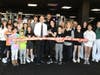 Darlene Sanner (holding scissors) and her husband, Josh (center), were joined by Amity Chamber CEO Barry Lee Cohen, fellow fitness enthusiasts, family, and friends.