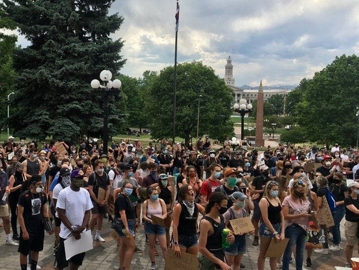 Thousands gather for a Black Lives Matter rally June 6. Many held signs that read, 'Justice for Elijah McClain.' 