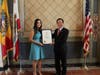 On behalf of Los Angeles Mayor Eric Garcetti, Commissioner Jessica Caloza of the Board of Public Works, left, presents a certificate to Dr. Hong for his dedication to preserve traditional Chinese culture and promote peace.