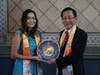 Commissioner Jessica Caloza ( left) is presented with a special clock by Dr. Hong. The face of the clock bears a compass of conscience, which symbolizes that all are encouraged to follow the guidance of their conscience at all times.