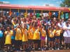 Fred Wasiak, President & CEO, FBSJ, Food Bank staff and Board members are joined by sponsors and children who participat