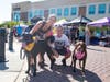 Families and their dogs enjoy a variety of vendors at last year’s Woofstock. 