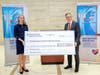 Shannon Sullivan, CEO of Teen Cancer America, and Mike Coiley, managing director of Healthcare Finance at First Citizens Bank, present a check to Hackensack University Medical Center to expand its Adolescent and Young Adult (AYA) program. 