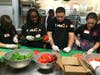 Youth serving in the partner nonprofit soup kitchen