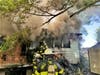 Hillsborough County firefighters rescued two people and the family dog after a fire destroyed their mobile home.