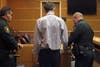 John Johnchuck is fingerprinted before being led away by court bailiffs. 