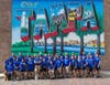 Warriors pose beneath the Tampa postcard mural. 
