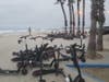 San Diego resident Karen Millhouse took this photo of e-scooters stacked up on a nearby beach. 